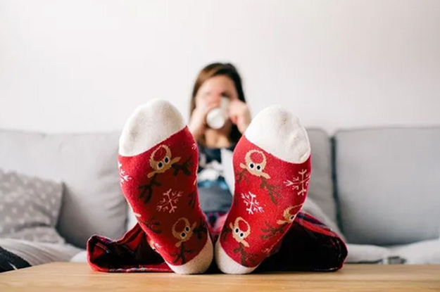 Woman with feet up on table showing her holiday socks
